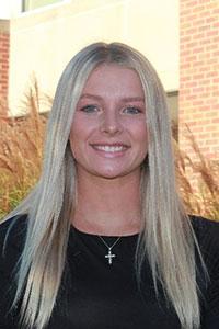 woman with long blonde hair wearing a black shirt